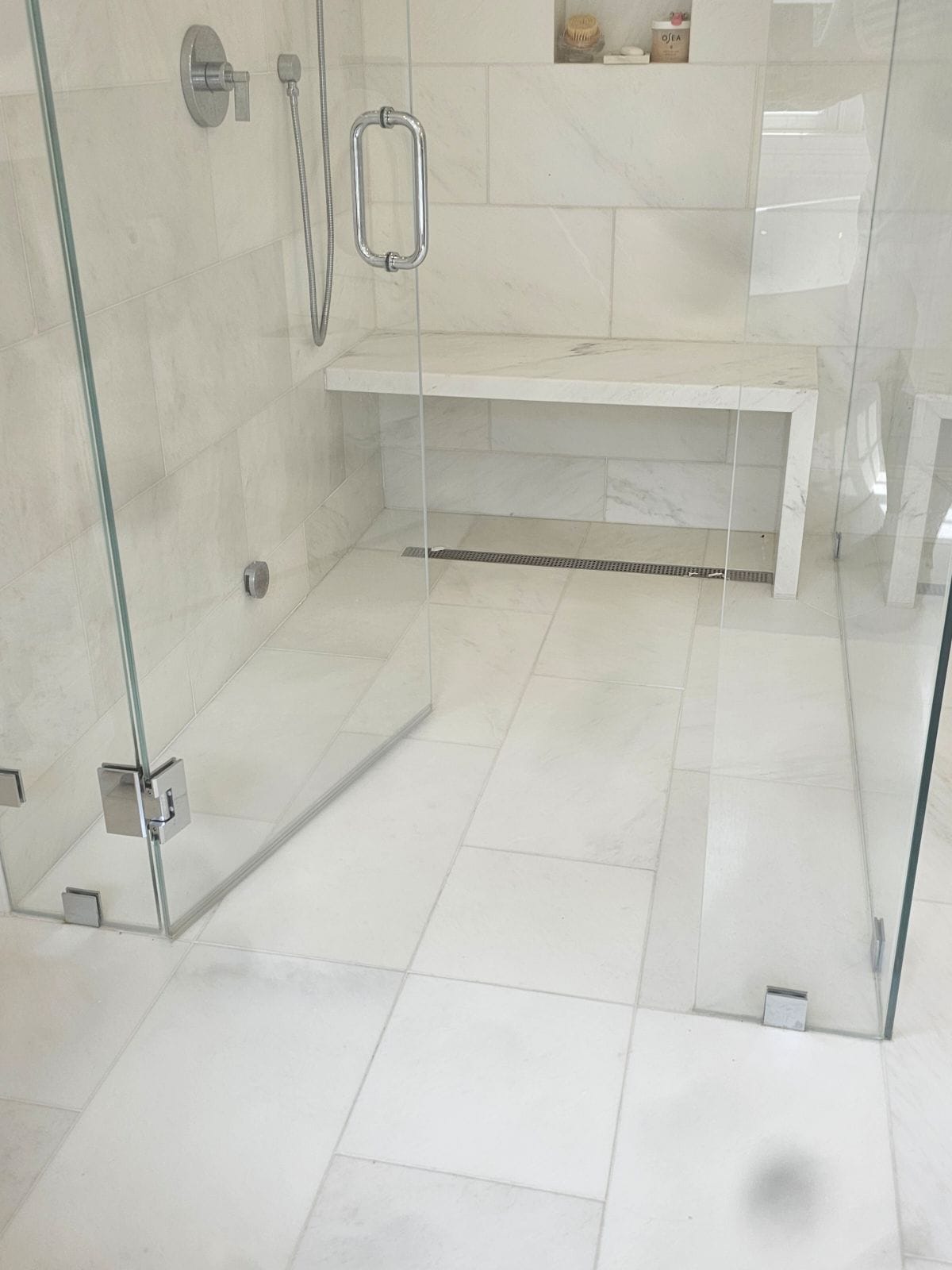 Finished bathroom with glass shower and built‑in bench
