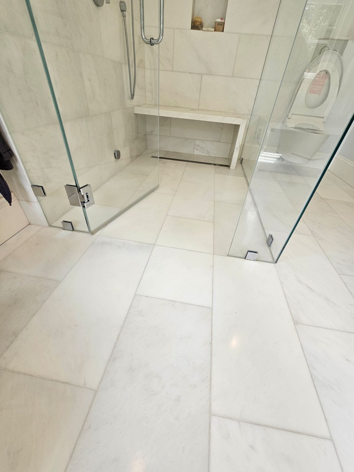 Marble tile shower with glass doors